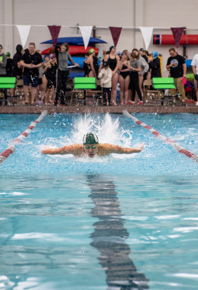 2.1.25 Senior Daniel Apostol swimming the 100 Butterfly at Missoula. 